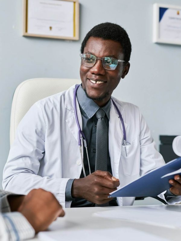 smiling-black-doctor-consulting-female-doctor-in-clinic.jpg